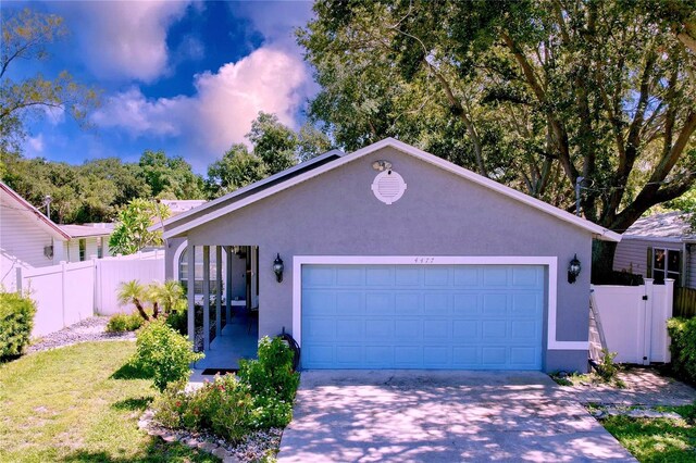 4477 67th St N, Saint Petersburg, FL 33709 - ranch-style house with stucco siding, an attached garage, fence, and driveway