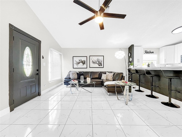 4477 67th St N, Saint Petersburg, FL 33709 - living room with marble finish floor, baseboards, lofted ceiling, and ceiling fan