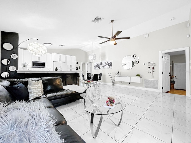 living room with ceiling fan and vaulted ceiling