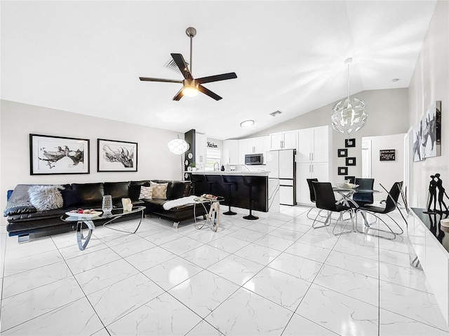 4477 67th St N, Saint Petersburg, FL 33709 - living room featuring vaulted ceiling, visible vents, marble finish floor, and ceiling fan with notable chandelier