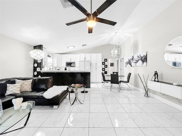 living room with ceiling fan with notable chandelier and lofted ceiling