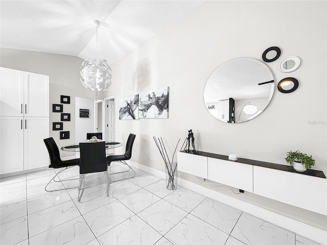 4477 67th St N, Saint Petersburg, FL 33709 - dining area featuring marble finish floor, baseboards, lofted ceiling, and a chandelier