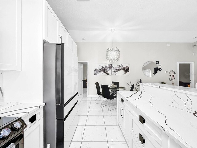 4477 67th St N, Saint Petersburg, FL 33709 - kitchen featuring marble finish floor, freestanding refrigerator, light stone countertops, black electric range oven, and white cabinetry