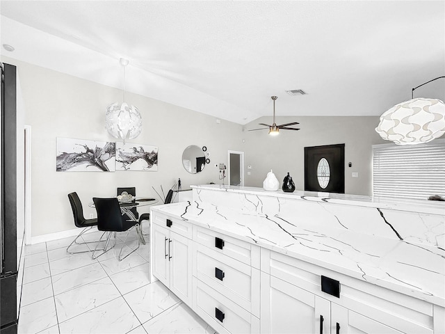 4477 67th St N, Saint Petersburg, FL 33709 - kitchen with visible vents, white cabinetry, lofted ceiling, marble finish floor, and light stone counters