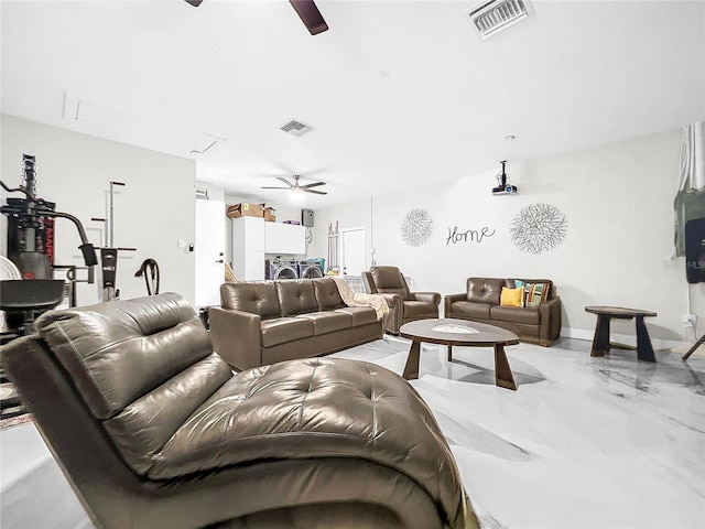 living room featuring ceiling fan and concrete flooring