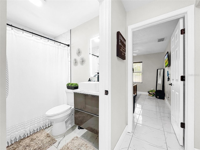 bathroom with vanity, toilet, and a shower with shower curtain