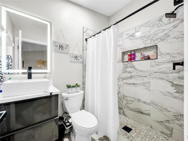 bathroom with vanity, toilet, and curtained shower