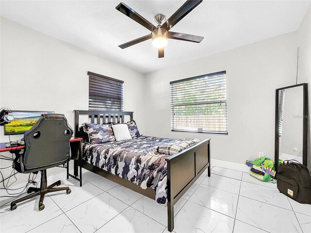 4477 67th St N, Saint Petersburg, FL 33709 - bedroom featuring marble finish floor, baseboards, and ceiling fan