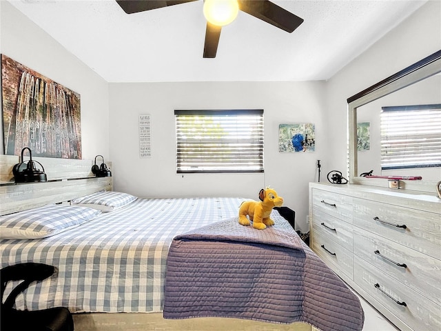 bedroom with multiple windows and ceiling fan