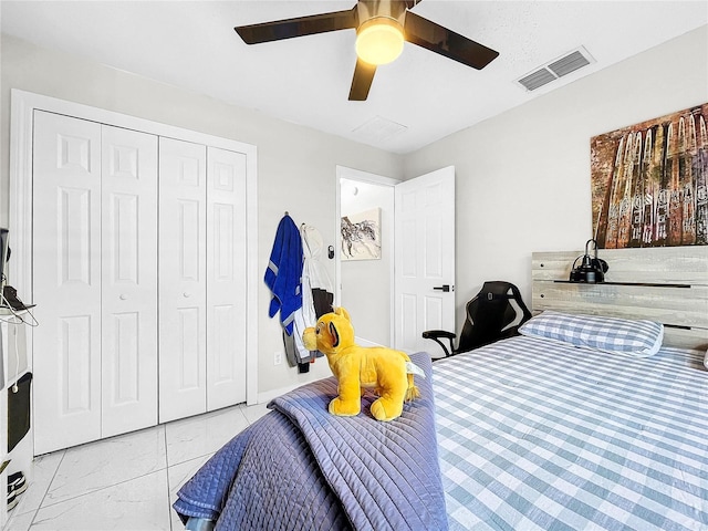 4477 67th St N, Saint Petersburg, FL 33709 - bedroom with ceiling fan, marble finish floor, visible vents, and a closet