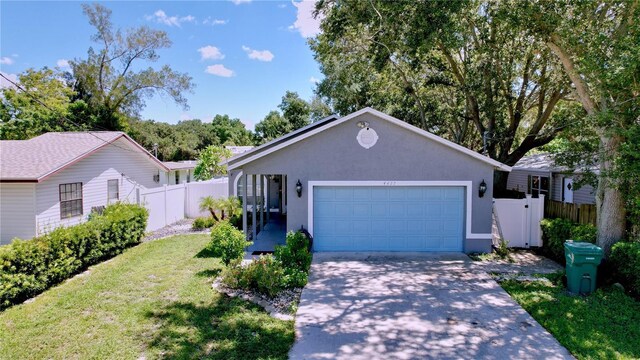 view of front facade with a garage and a front lawn