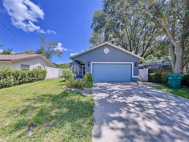 view of front of property with a garage and a front lawn