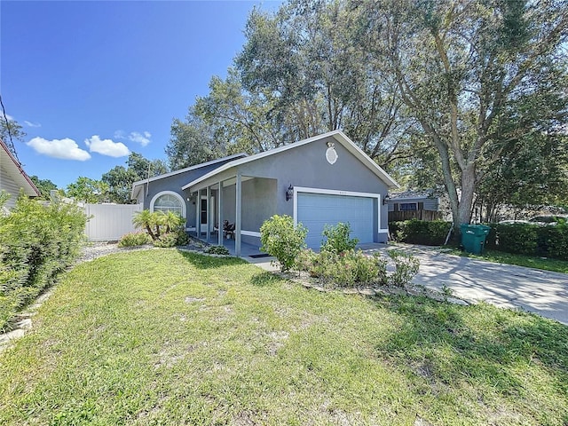 view of front of property with a garage and a front lawn