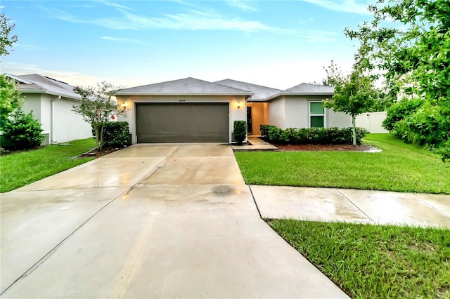 view of front facade with a garage and a front yard