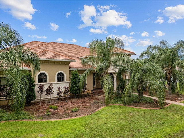 mediterranean / spanish house with a front lawn