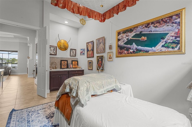 bedroom with light tile patterned floors and sink