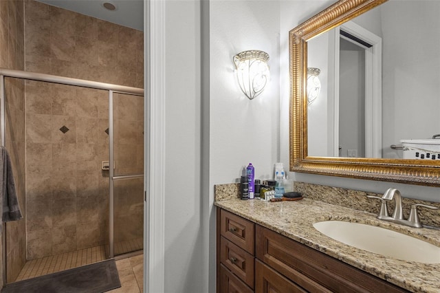 bathroom featuring tile patterned flooring, vanity, and an enclosed shower