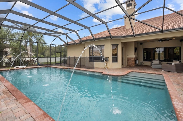 view of pool featuring a lanai, an outdoor living space, pool water feature, ceiling fan, and a patio