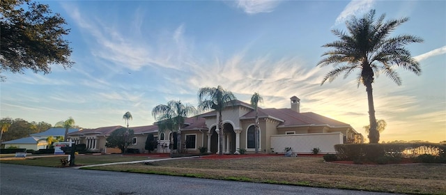 mediterranean / spanish-style house featuring a yard