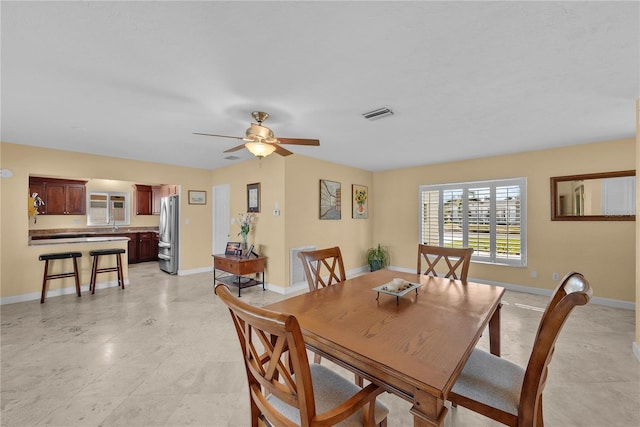 dining space with ceiling fan