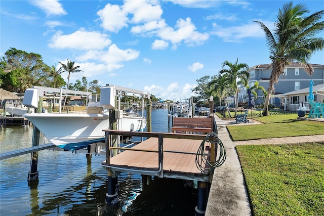 dock area featuring a lawn and a water view