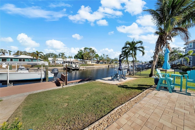 view of dock featuring a yard and a water view