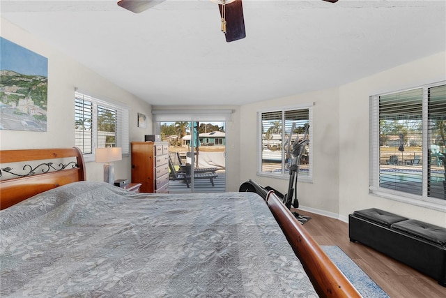 bedroom featuring access to outside, ceiling fan, and wood-type flooring