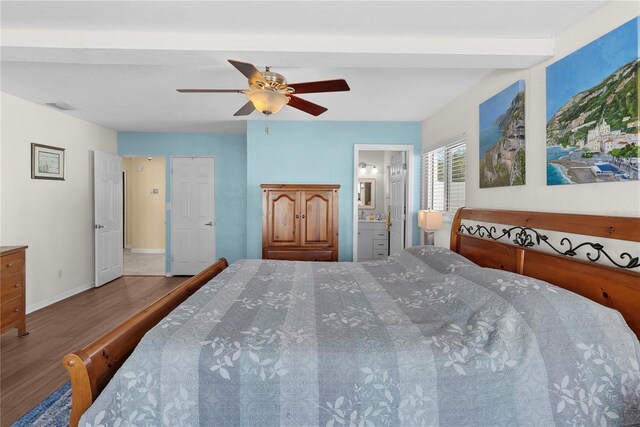 bedroom featuring hardwood / wood-style floors, ceiling fan, and ensuite bath