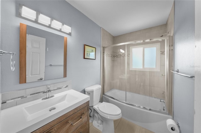 full bathroom featuring combined bath / shower with glass door, tasteful backsplash, tile patterned floors, vanity, and toilet