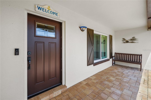 view of exterior entry with a porch