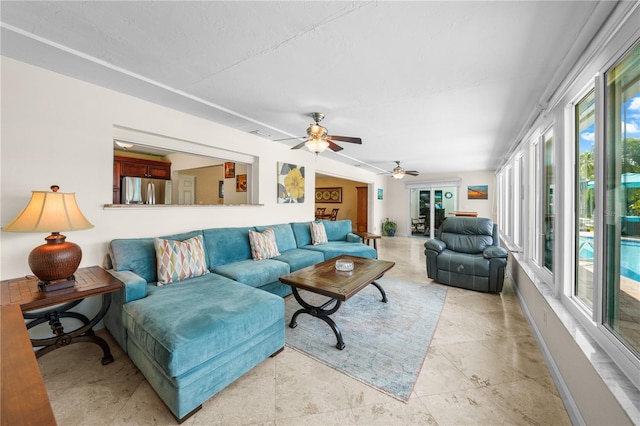 living room with ceiling fan and a wealth of natural light