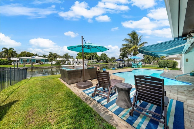 view of swimming pool with a water view, a yard, and a patio