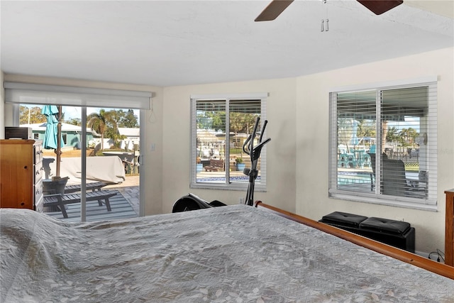 bedroom with access to outside, multiple windows, and ceiling fan