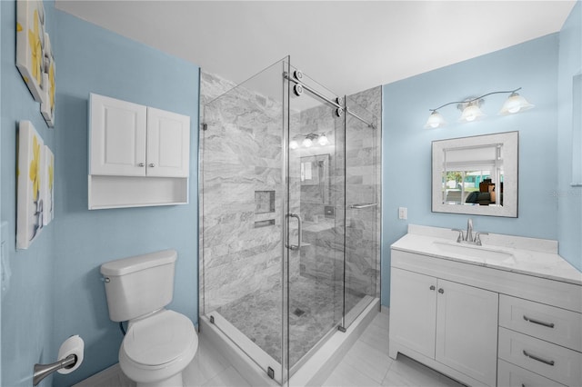 bathroom featuring tile patterned floors, vanity, toilet, and walk in shower