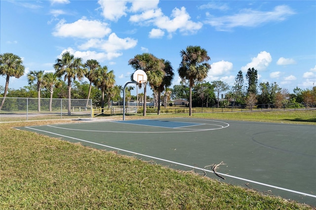 view of basketball court with a yard