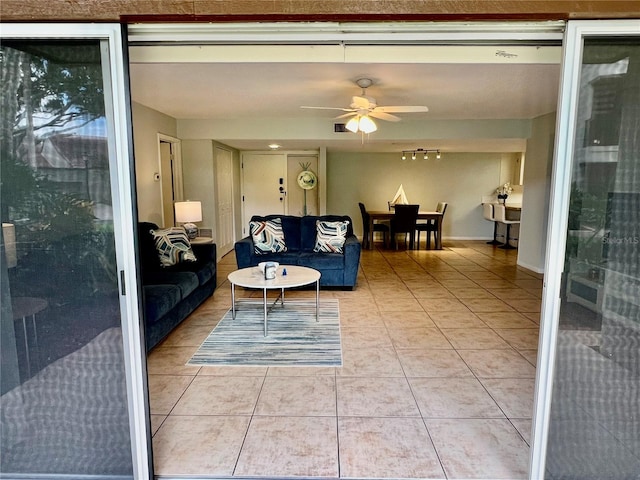 living room with light tile patterned floors and ceiling fan