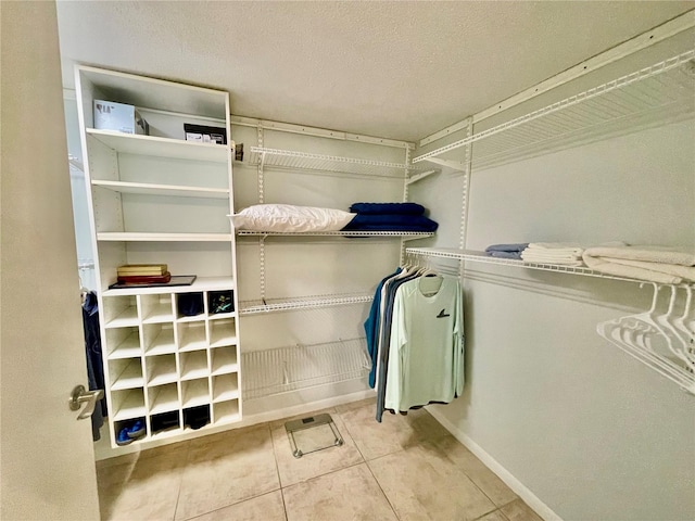 spacious closet featuring light tile patterned floors