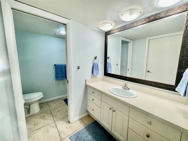 bathroom with vanity, toilet, and tile patterned floors