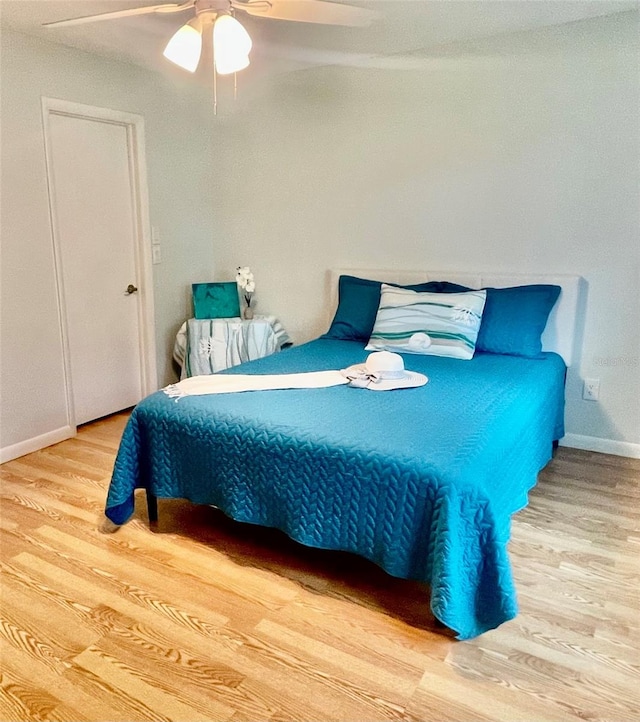 bedroom with ceiling fan and light hardwood / wood-style floors