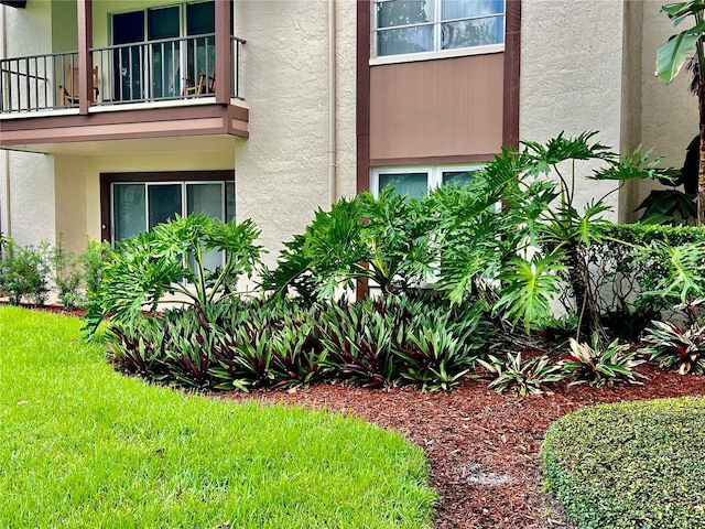 exterior space with a balcony and a yard