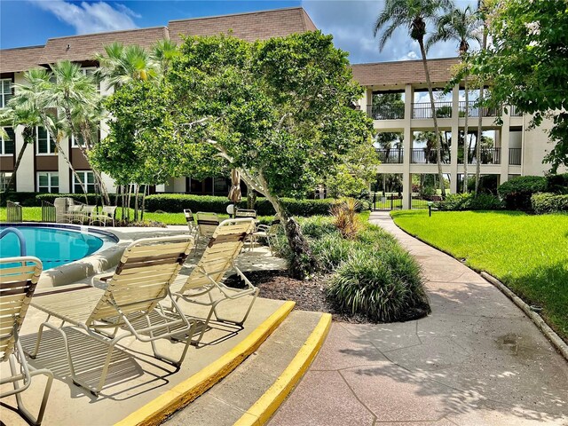 view of swimming pool with a lawn