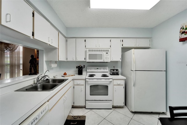 kitchen with a textured ceiling, sink, white appliances, and white cabinetry