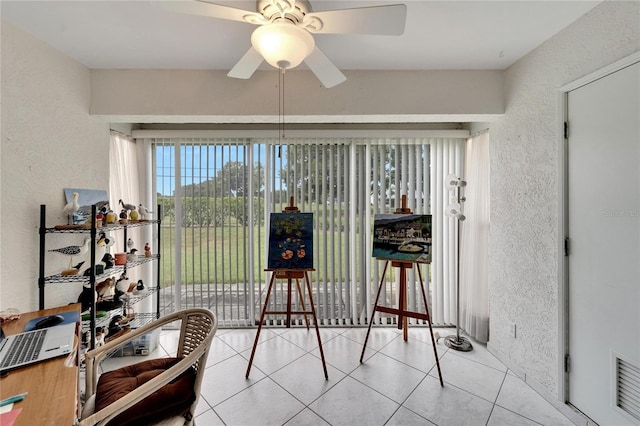 sunroom / solarium featuring ceiling fan