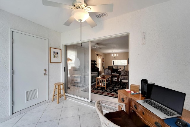 interior space featuring ceiling fan with notable chandelier