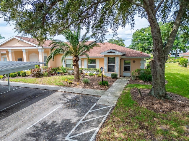 view of front facade featuring a front yard and a carport