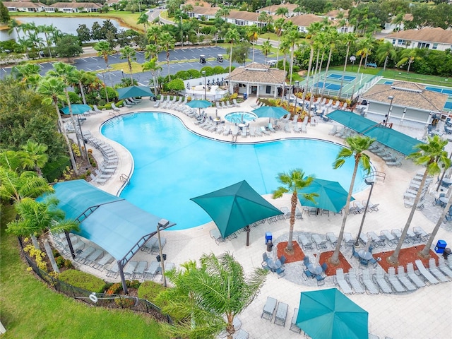 view of swimming pool with a water view and a patio