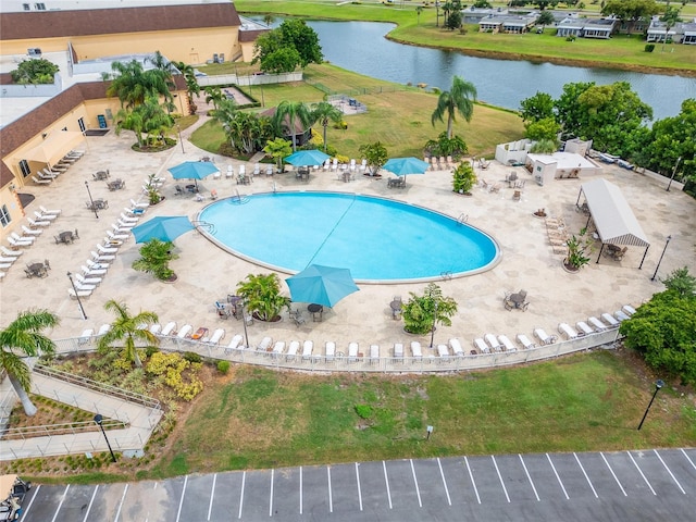 view of pool with a patio area and a water view