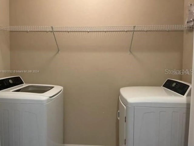 clothes washing area featuring washer and clothes dryer