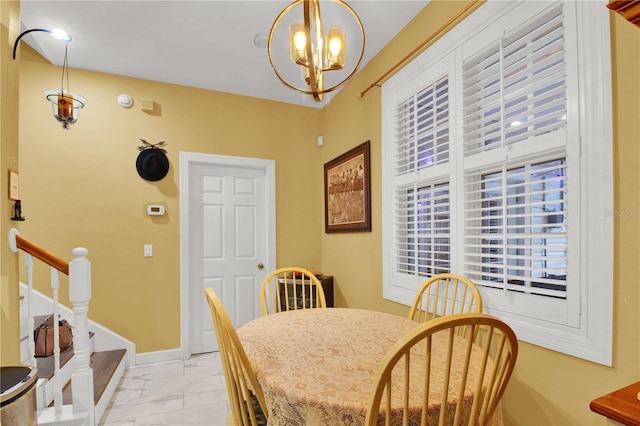 dining space with an inviting chandelier