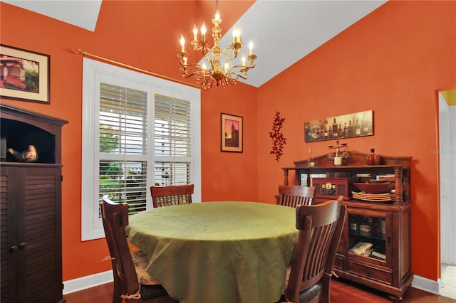 dining area with high vaulted ceiling, dark hardwood / wood-style floors, and a chandelier